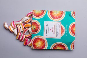 Blood Orange Tamalitoz pouch and candy laying down